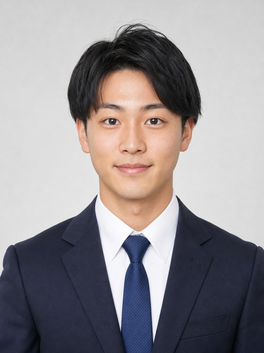 Japanese man in a navy suit on a light gray background